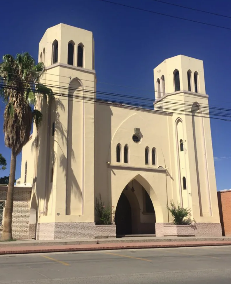 White stucco chapel facade with bell tower and cross at Senecú, Ciudad Juárez.